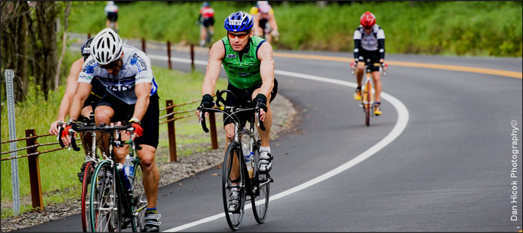 Cyclists Climbing Hill